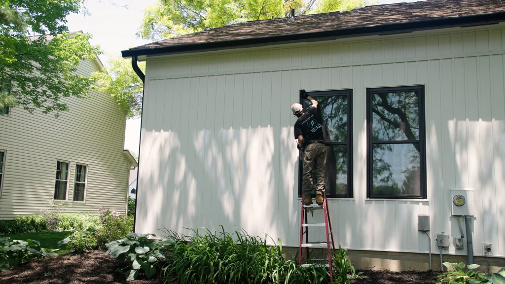 Window installer of Indianapolis Window Company done replacing an old window