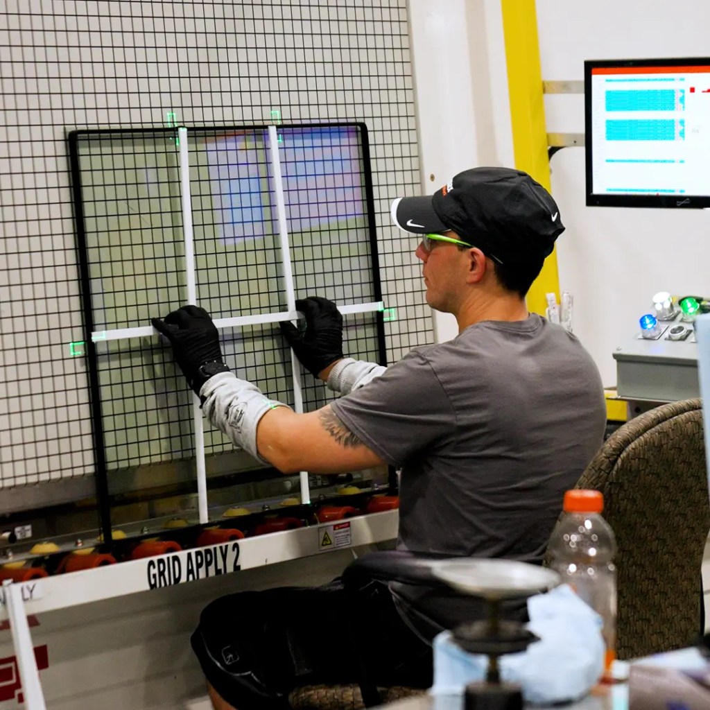 Window manufacturer doing fitments on the window glass